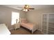 Comfortable bedroom with a ceiling fan, natural light, and convenient bookshelf at 2562 Kennesaw Springs Nw Ct, Kennesaw, GA 30144