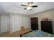 Well-lit bedroom with a tray ceiling, fan, double closets, and ample furniture space at 2562 Kennesaw Springs Nw Ct, Kennesaw, GA 30144