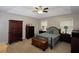 Spacious bedroom with a tray ceiling, ceiling fan, and natural light from two windows at 2562 Kennesaw Springs Nw Ct, Kennesaw, GA 30144