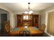 Formal dining room featuring wood table set, matching hutch, archway, and door with curtains at 2562 Kennesaw Springs Nw Ct, Kennesaw, GA 30144