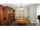 Dining room with wood floors, matching furniture, light fixture, and curtains over a door at 2562 Kennesaw Springs Nw Ct, Kennesaw, GA 30144