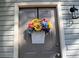 Close-up of front door featuring a beautiful floral arrangement, lantern and gray wood siding at 2562 Kennesaw Springs Nw Ct, Kennesaw, GA 30144