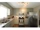 Modern kitchen featuring granite countertops, stainless steel appliances, wood floors, and overhead lighting at 2562 Kennesaw Springs Nw Ct, Kennesaw, GA 30144