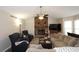 Cozy living room features a stone fireplace, vaulted ceiling, comfortable seating, and natural light at 2562 Kennesaw Springs Nw Ct, Kennesaw, GA 30144