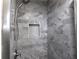 Bathroom featuring a shower with neutral marble tiles and a built-in niche for storage at 2562 Kennesaw Springs Nw Ct, Kennesaw, GA 30144