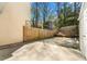 Fenced backyard space with gravel area, a small retaining wall, and greenery visible beyond the fence at 2970 Aspen Woods Entry, Atlanta, GA 30360