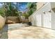 Backyard featuring a gravel area, a small retaining wall, and access doors on the side of the home at 2970 Aspen Woods Entry, Atlanta, GA 30360
