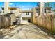 Spacious backyard with a gravel area, surrounded by a wooden fence and neighboring townhomes at 2970 Aspen Woods Entry, Atlanta, GA 30360