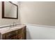 Elegant powder room with wainscoting, granite counter, and stylish mirror at 2970 Aspen Woods Entry, Atlanta, GA 30360