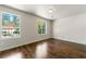 Bedroom with new hardwood floors, fresh paint, and an abundance of natural light from two large windows at 2970 Aspen Woods Entry, Atlanta, GA 30360