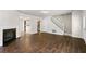 Open-concept living room with stairs and wood-look tile flooring throughout at 2970 Aspen Woods Entry, Atlanta, GA 30360