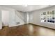 Bright living room with stairs, white trim and wood-look tile floors at 2970 Aspen Woods Entry, Atlanta, GA 30360