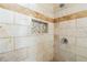Close-up of remodeled shower featuring decorative tile, a built-in shower niche, and updated shower head at 2970 Aspen Woods Entry, Atlanta, GA 30360