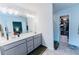 Bright bathroom with double vanity, modern fixtures, and an adjacent walk-in closet at 3132 Meadowstone Sw Ln, Atlanta, GA 30331