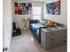 Cozy bedroom with blue daybed, gray dresser, and carpet flooring, with large wall posters at 3132 Meadowstone Sw Ln, Atlanta, GA 30331