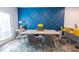 Stylish dining area with a statement blue accent wall, modern furniture, and lots of natural light at 3132 Meadowstone Sw Ln, Atlanta, GA 30331