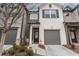 Charming two-story townhome with a well-maintained front yard, gray garage door, and a welcoming entrance at 3132 Meadowstone Sw Ln, Atlanta, GA 30331