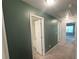 Neutral hallway with modern lighting, leading to doorways, and carpet flooring at 3132 Meadowstone Sw Ln, Atlanta, GA 30331