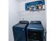 Efficient laundry area with newer washer and dryer set, ample storage and shelving for organization at 3132 Meadowstone Sw Ln, Atlanta, GA 30331