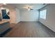 Spacious living room with wood-look flooring, a ceiling fan, and large windows providing natural light at 3132 Meadowstone Sw Ln, Atlanta, GA 30331