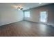 Bright living room featuring wood-look floors, neutral walls, and a glass door leading to the outdoors at 3132 Meadowstone Sw Ln, Atlanta, GA 30331