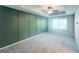 Expansive main bedroom with decorative wall trim, ceiling fan and neutral carpet, ideal for relaxation at 3132 Meadowstone Sw Ln, Atlanta, GA 30331