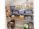 Organized pantry with wire shelves, multiple storage bins, and a variety of food and household items at 3132 Meadowstone Sw Ln, Atlanta, GA 30331
