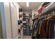 Organized walk-in closet with shelving, hanging racks, and space for shoes at 3132 Meadowstone Sw Ln, Atlanta, GA 30331