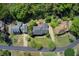 Overhead view of a neighborhood street featuring well-maintained homes and manicured lawns at 5162 Charlemagne Sw Way, Lilburn, GA 30047