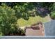 Aerial view of a deck and backyard bordered by mature trees and a home with a gray roof at 5162 Charlemagne Sw Way, Lilburn, GA 30047