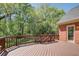 Wooden back deck offering a view of the wooded backyard at 5162 Charlemagne Sw Way, Lilburn, GA 30047