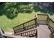 Elevated back deck with stairs descending to the backyard at 5162 Charlemagne Sw Way, Lilburn, GA 30047