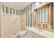 Full bathroom featuring a shower, vanity, mirror, and patterned wallpaper at 5162 Charlemagne Sw Way, Lilburn, GA 30047