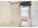 Tiled bathroom with tub, shower, window with floral wallpaper at 5162 Charlemagne Sw Way, Lilburn, GA 30047