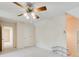 Bedroom featuring ceiling fan, closet and access to hallway at 5162 Charlemagne Sw Way, Lilburn, GA 30047