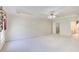Spacious bedroom features neutral walls, carpet, tray ceiling with fan, and doorways to closet and bathroom at 5162 Charlemagne Sw Way, Lilburn, GA 30047