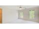 Sunlit bedroom with neutral colors and carpeting, bright natural light from two windows at 5162 Charlemagne Sw Way, Lilburn, GA 30047