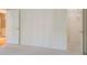 Neutral bedroom with white walls and carpet, with a closet and bathroom door visible at 5162 Charlemagne Sw Way, Lilburn, GA 30047