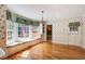 Sunlit eat-in area with built-in bench, floral wallpaper, and hardwood floors at 5162 Charlemagne Sw Way, Lilburn, GA 30047