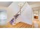 A foyer with hardwood floors, staircase, chandelier, and white trim at 5162 Charlemagne Sw Way, Lilburn, GA 30047