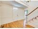 Bright foyer features gleaming hardwood floors and a white front door and trim at 5162 Charlemagne Sw Way, Lilburn, GA 30047