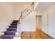 Spacious foyer with hardwood floors and elegant staircase with chandelier at 5162 Charlemagne Sw Way, Lilburn, GA 30047