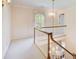 Bright hallway with a window and decorative cornice, featuring white carpets and a chandelier at 5162 Charlemagne Sw Way, Lilburn, GA 30047