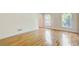 Bright living room with hardwood floors, white walls, and large windows at 5162 Charlemagne Sw Way, Lilburn, GA 30047
