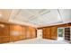 Large living room showcasing paneled walls and decorative ceiling at 5162 Charlemagne Sw Way, Lilburn, GA 30047