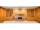 Cozy living room with a fireplace, built-in bookshelves, and wood paneling at 5162 Charlemagne Sw Way, Lilburn, GA 30047