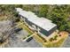 Aerial view of a multi-unit complex featuring mature trees, landscaping, and parking at 89 De Arc Nw Pl, Atlanta, GA 30327