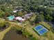 Community aerial view featuring a pool, clubhouse, and tennis courts surrounded by lush greenery at 89 De Arc Nw Pl, Atlanta, GA 30327