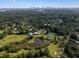 An aerial community view featuring a pond and lush surroundings with the Atlanta skyline in the distance at 89 De Arc Nw Pl, Atlanta, GA 30327