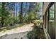 View of the backyard area with lush greenery and building exterior at 89 De Arc Nw Pl, Atlanta, GA 30327